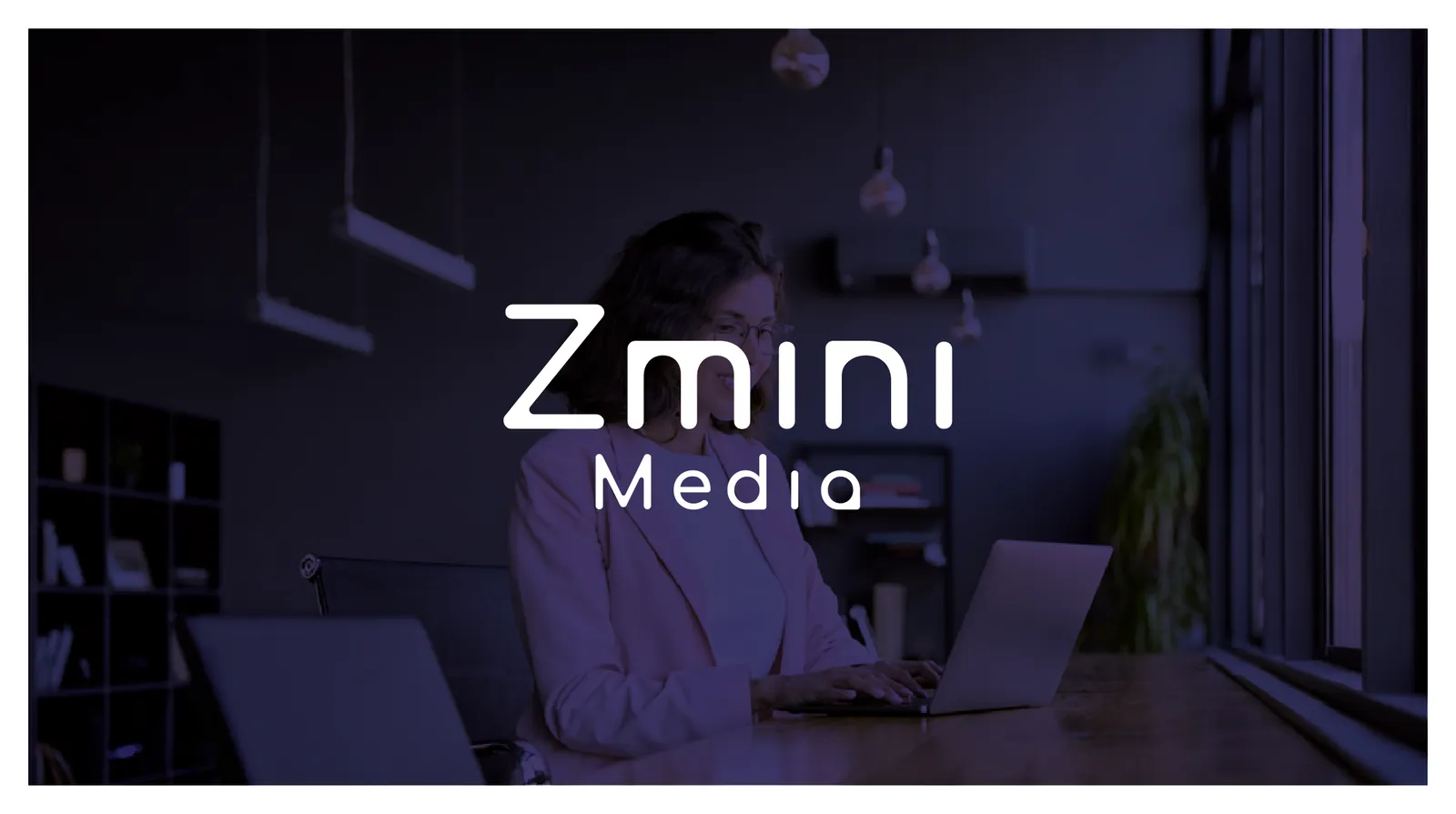 Business owner working on a laptop in a dimly lit office